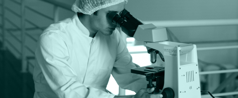 Researcher in a lab looking in a microscope