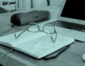 Eye glasses on an open book page